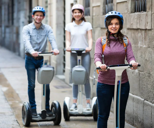 Laughing friends posing on segways in vacation