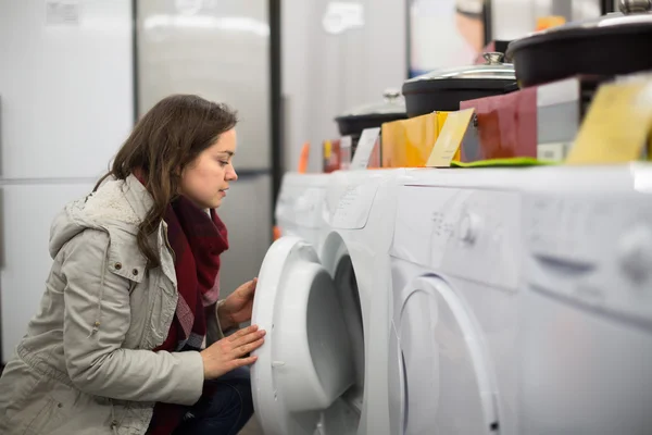 Woman choosing washing machine