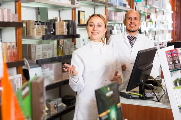 Pharmacists standing with a cash desk