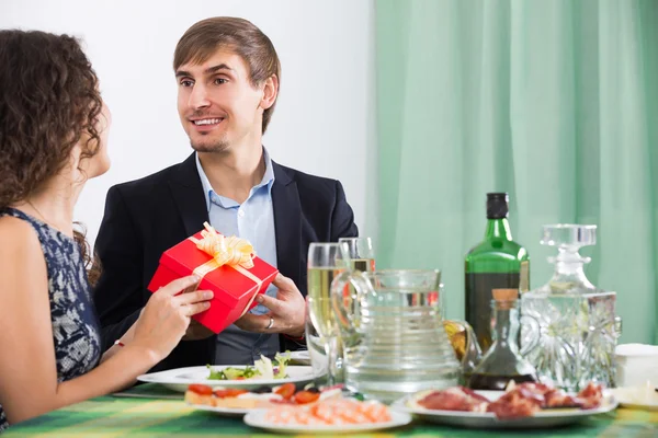 Adult  man giving present to woman