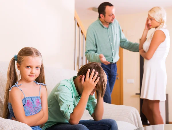Sad siblings and quarrel parents
