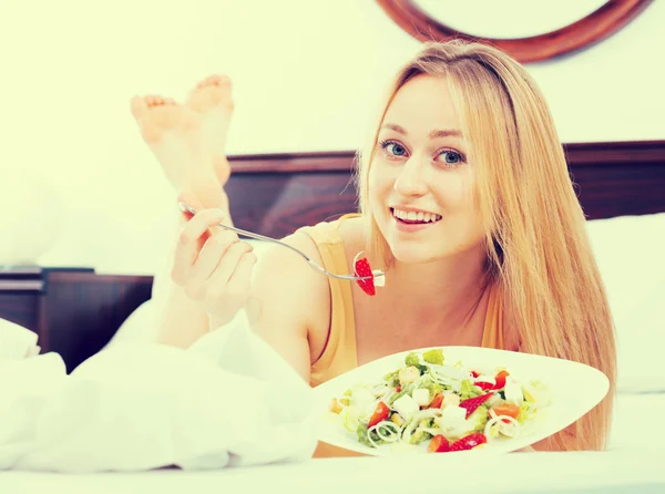 Woman eating salad