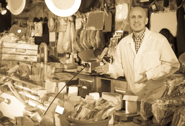 Salesman selling cheese and jamon