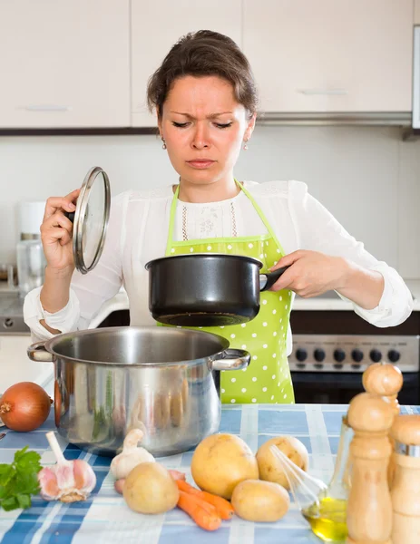 Housewife feeling bad smell from pan