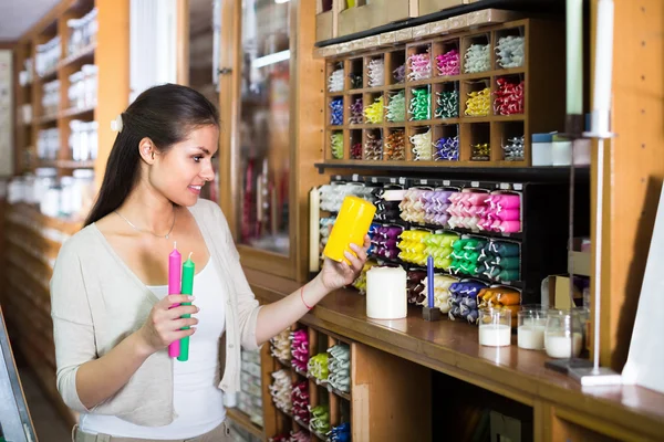 Woman shopping multicolored candles