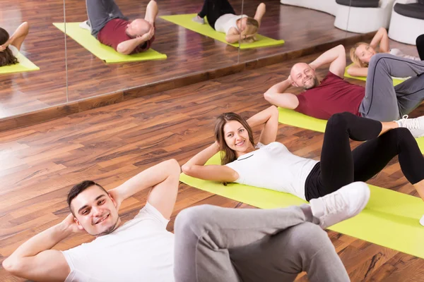 Adults having group fitness class