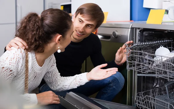 Couple choosing new dish washing machine