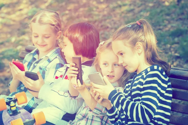 Kids with mobile devices outdoor
