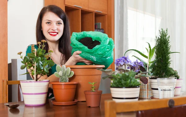 Young woman working with  flower in pots