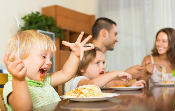 Family of four eating spaghetti