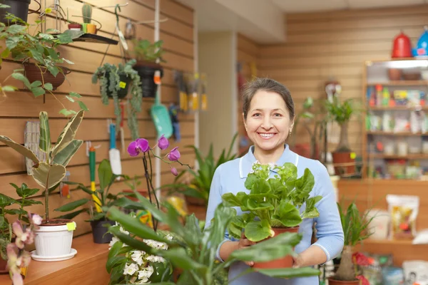 Happy mature woman in  flowers store