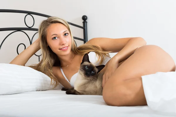 Woman with cat in bedroom