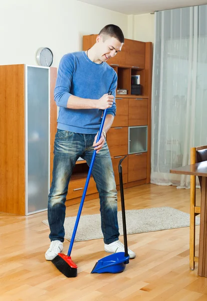 Man  sweeping the floor  at home