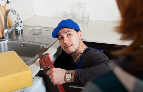 Plumber repairing a kitchen sink