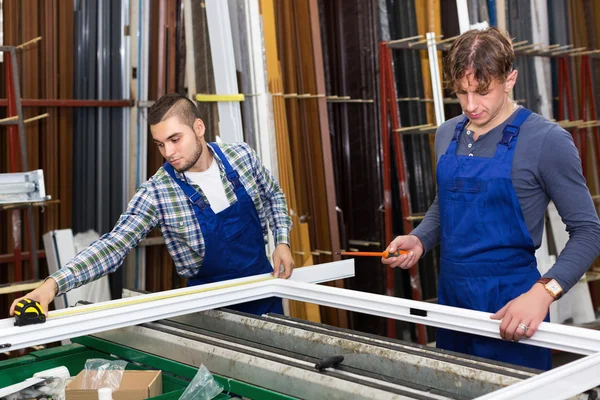 Two careful workers inspecting windows