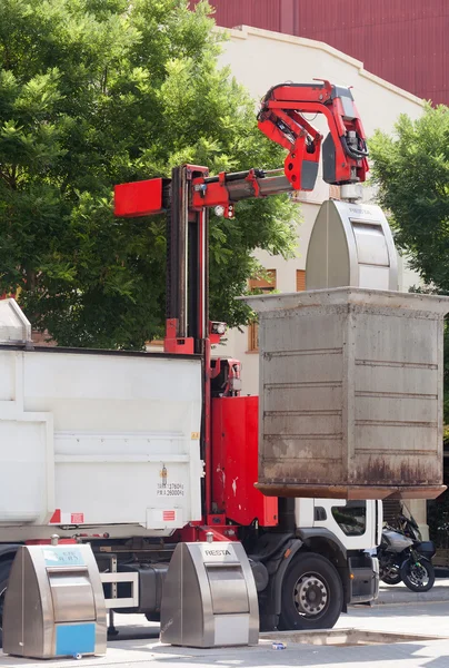 Recycling truck picking up  cans