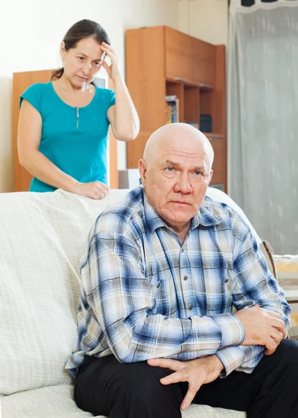 Unhappy mature man with sad wife