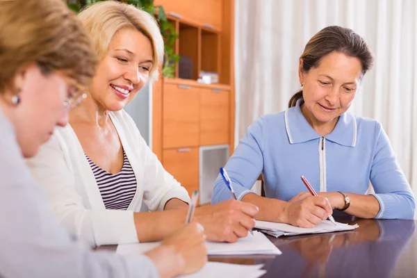 Mature women working with documents