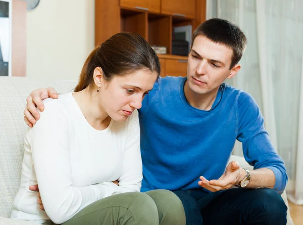 Sad woman, man consoling her