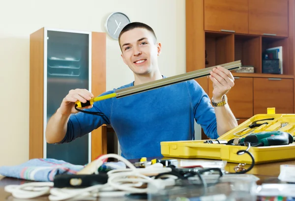 Happy man doing something with  tools