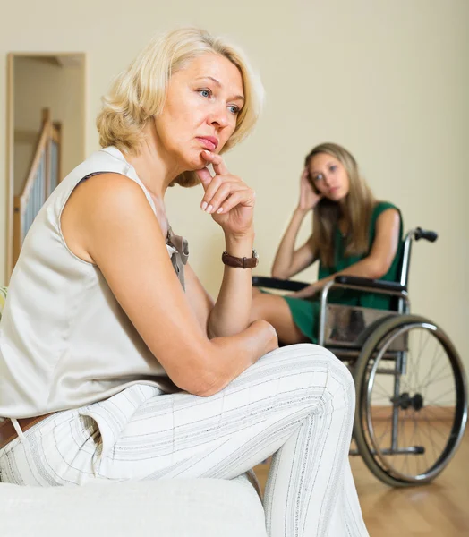 Woman and handicapped female having quarrel