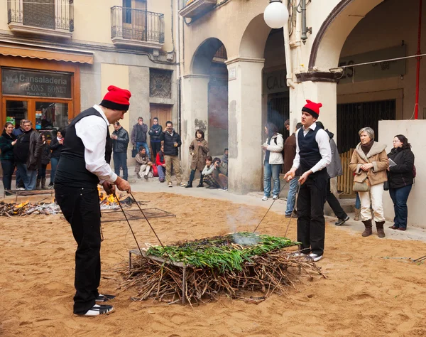 Men   cooking calsot on bonfire