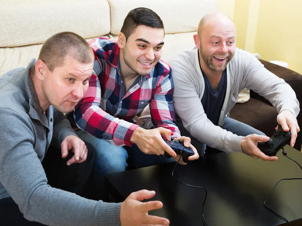 Men relaxing with video game