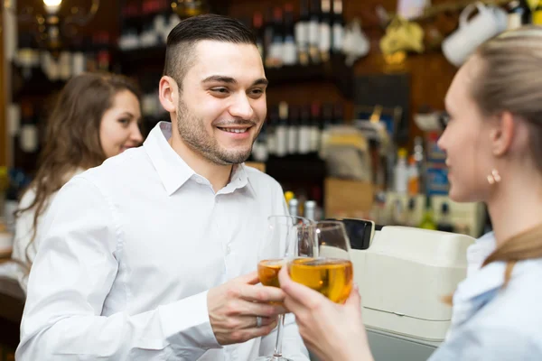 Smiling young couple drinking wine