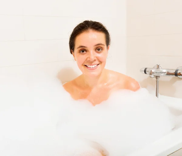 Girl with foam in bath