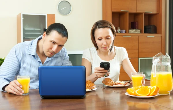 Couple using electronic devices
