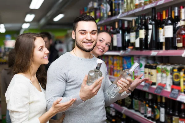 Customers  near shelves with canned goods