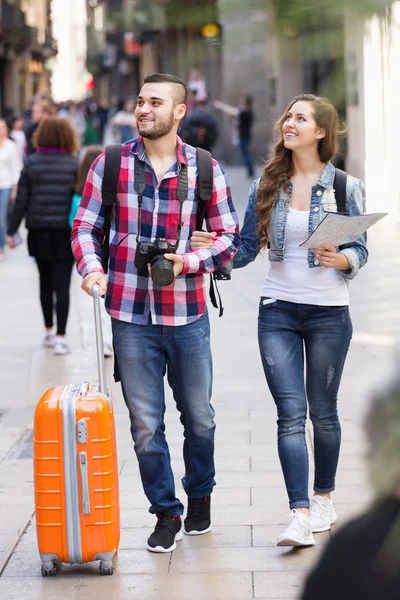 Couple with luggage walking
