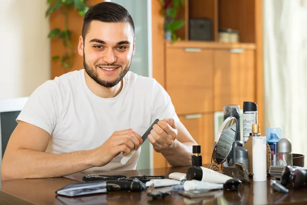 Man doing manicure at home