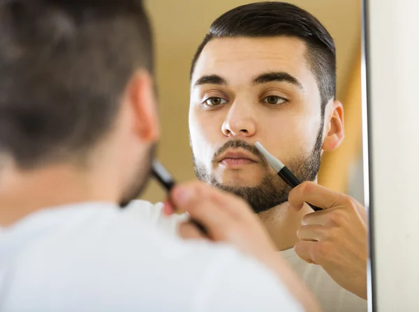 Man shaving beard