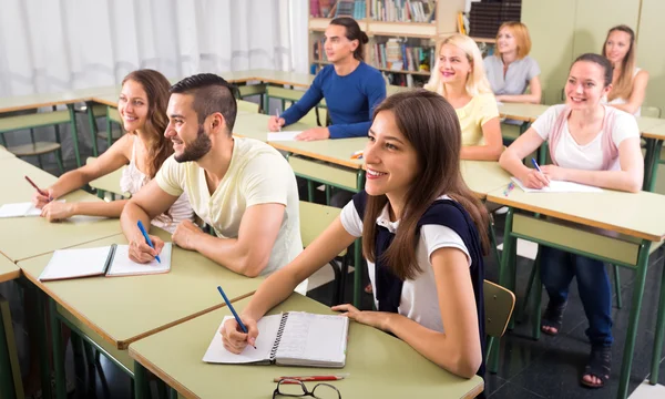 Happy students in college classroom