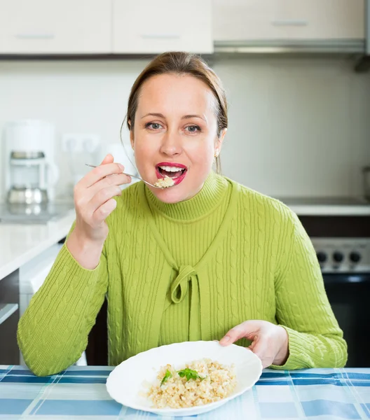 Healthy woman eating rice