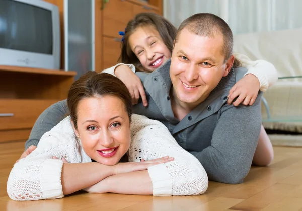 Happy family of three at home