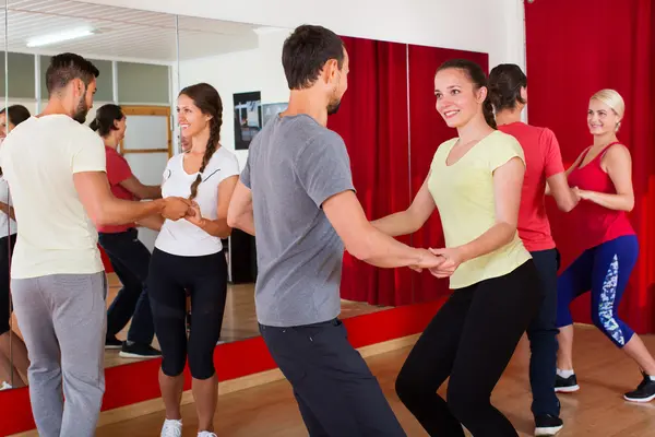 Men and women enjoying active dance