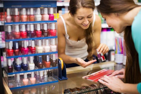 Clerk serving purchaser with nail polish