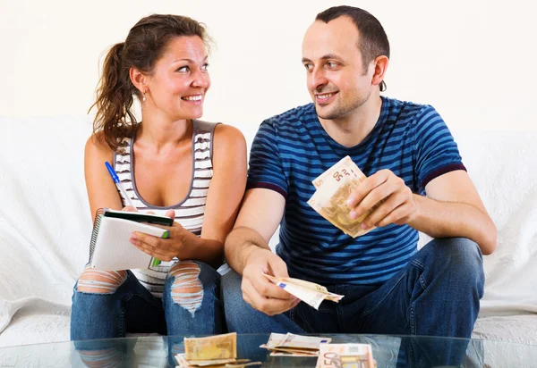 Sly wife asking smiling man money