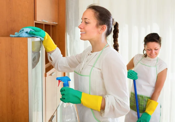 Women make cleaning in the living-room