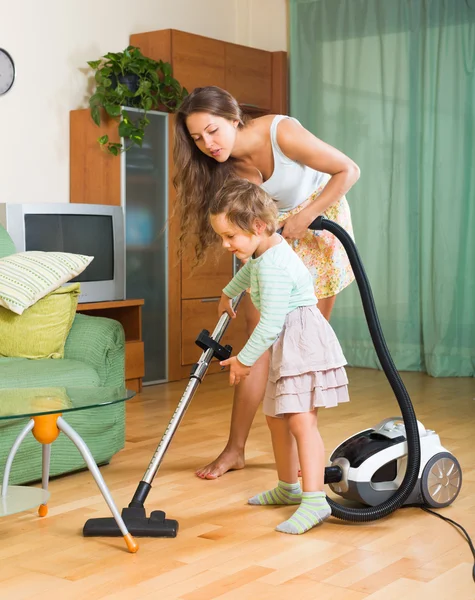 Family cleaning home with vacuum cleaner