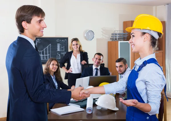 Superintendent and main specialist handshaking