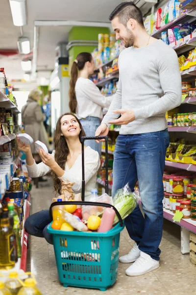 People shelves with canned goods