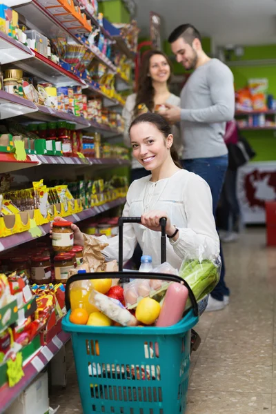 People shelves with canned goods