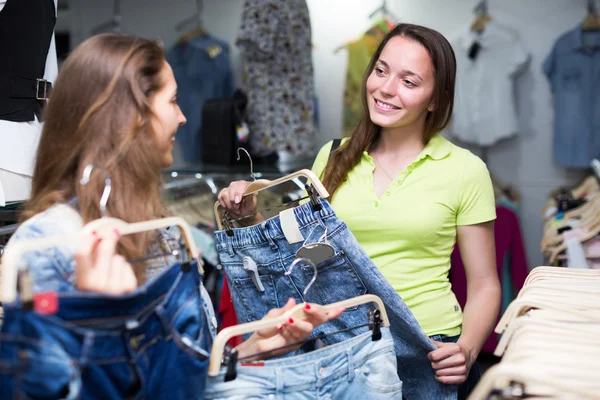 Girls buying pants in store