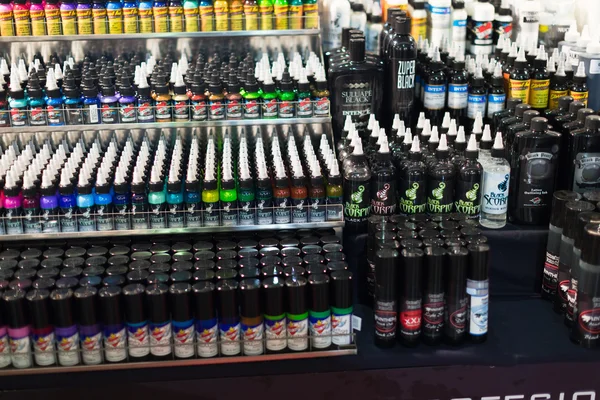 Many tubes of professional tattoo paint at showcase.