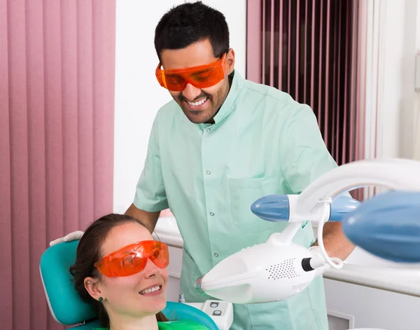 Patient at procedure of teeth whitening