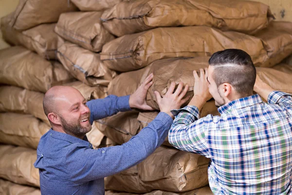 Workers carrying bags of cement