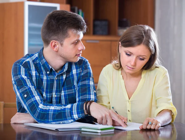Spouses with documents for bank at home